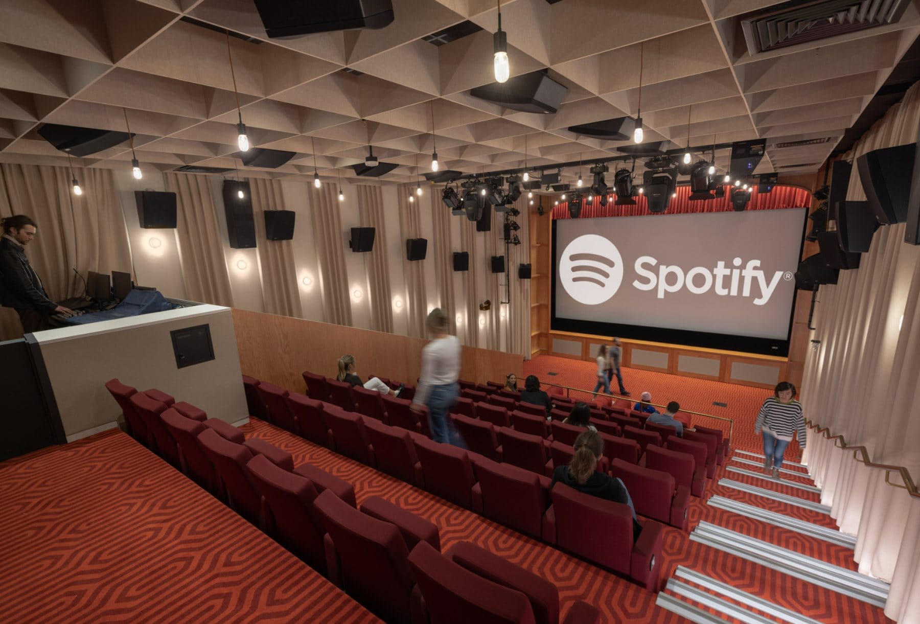 Screening Room · the branded screen behind tiered seating and acoustic drapery