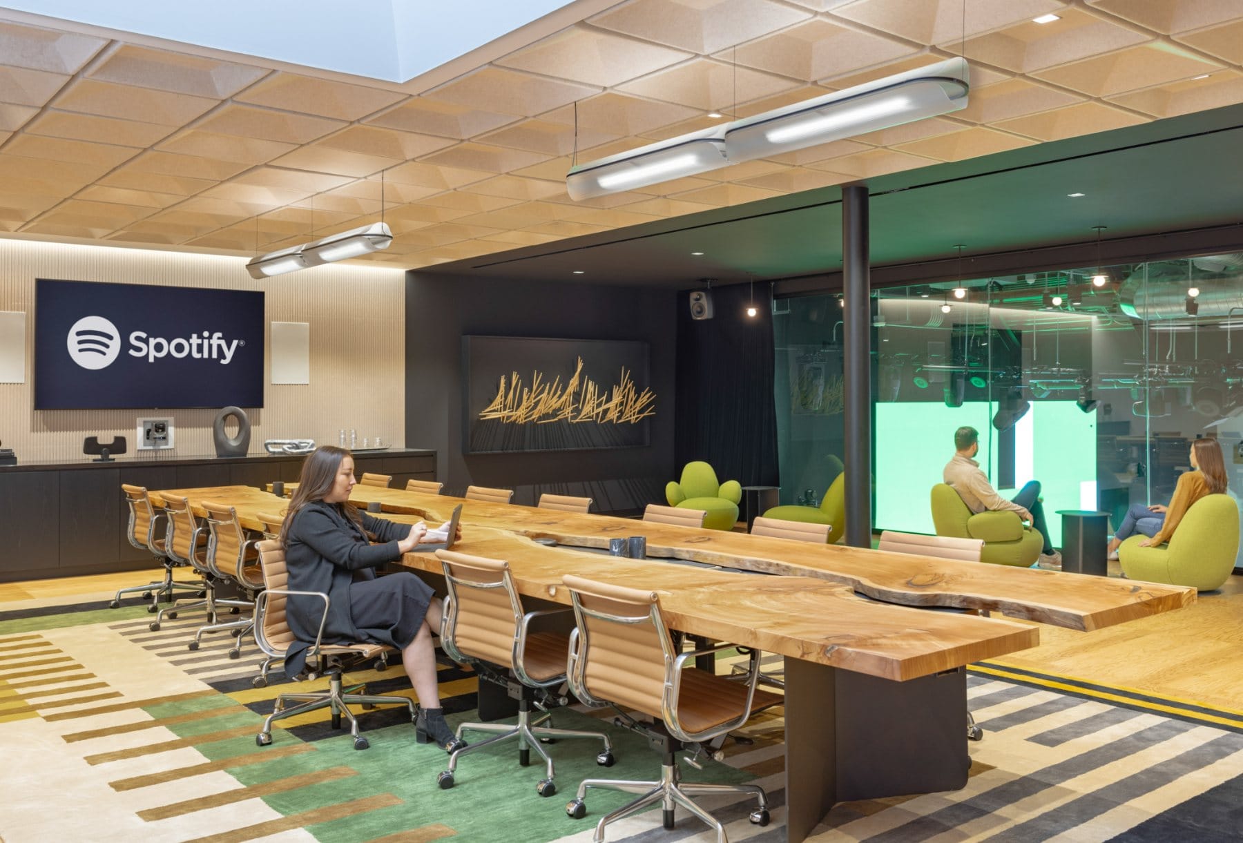 Cafe; · yellow stools at the central counter, with brand graphics overhead