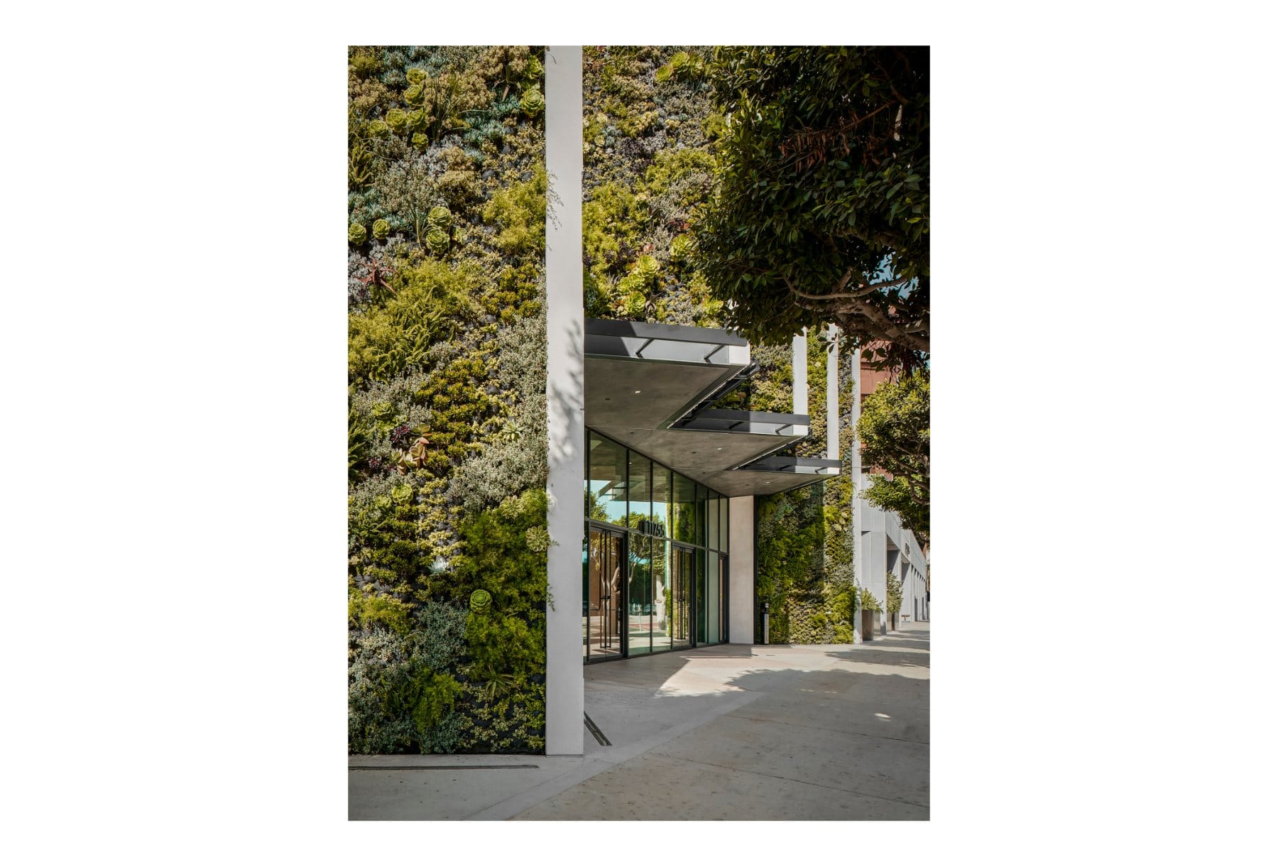 Tenant lounge · a marble bar with curated objects, opening to the blue stair and conference levels beyond