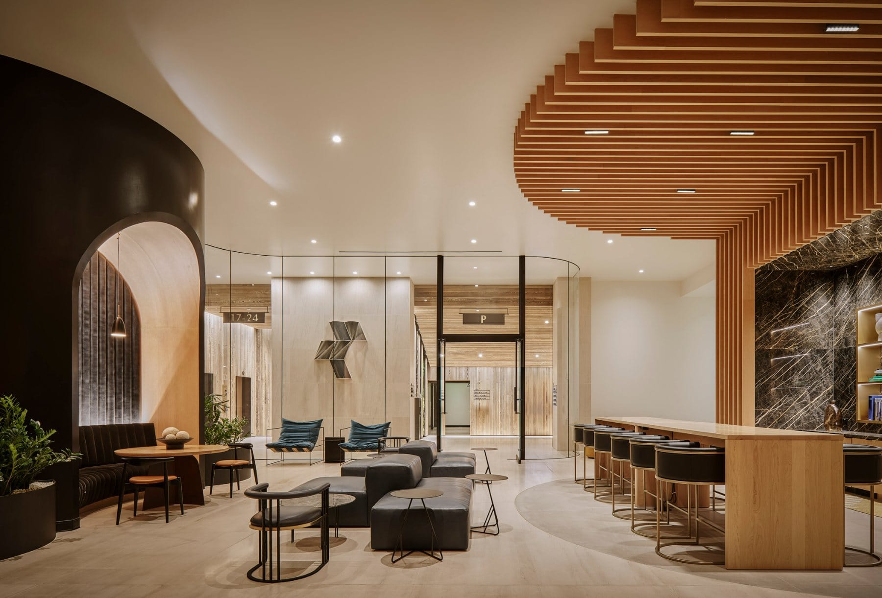 Outdoor terrace · rattan seating below a slatted wood pergola, extending the workplace into the landscape